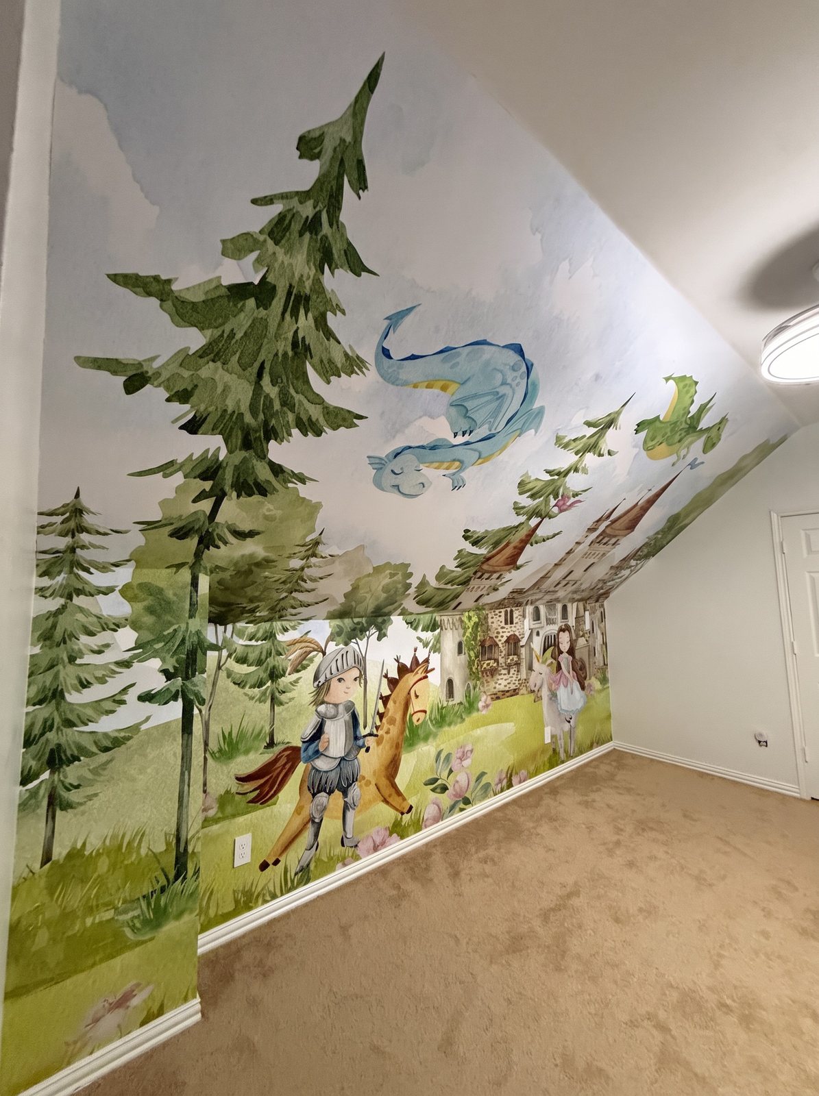 Children's room with a watercolor mural of pine trees, a knight on a horse and flying dragons covering a wall and sloped ceiling.